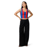 A woman modeling a sleeveless crop top with vertical red and blue stripes, paired with black wide-leg pants, against a plain white studio background.